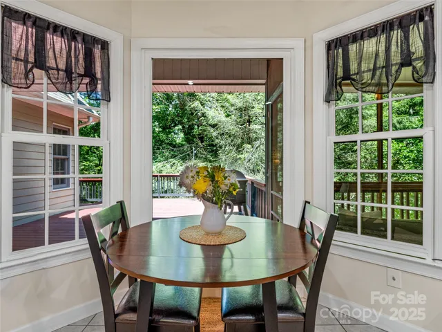 a bathroom with a double vanity sink a large mirror a bathtub and next to a window