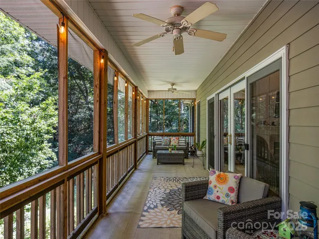 a view of balcony with wooden floor and fence