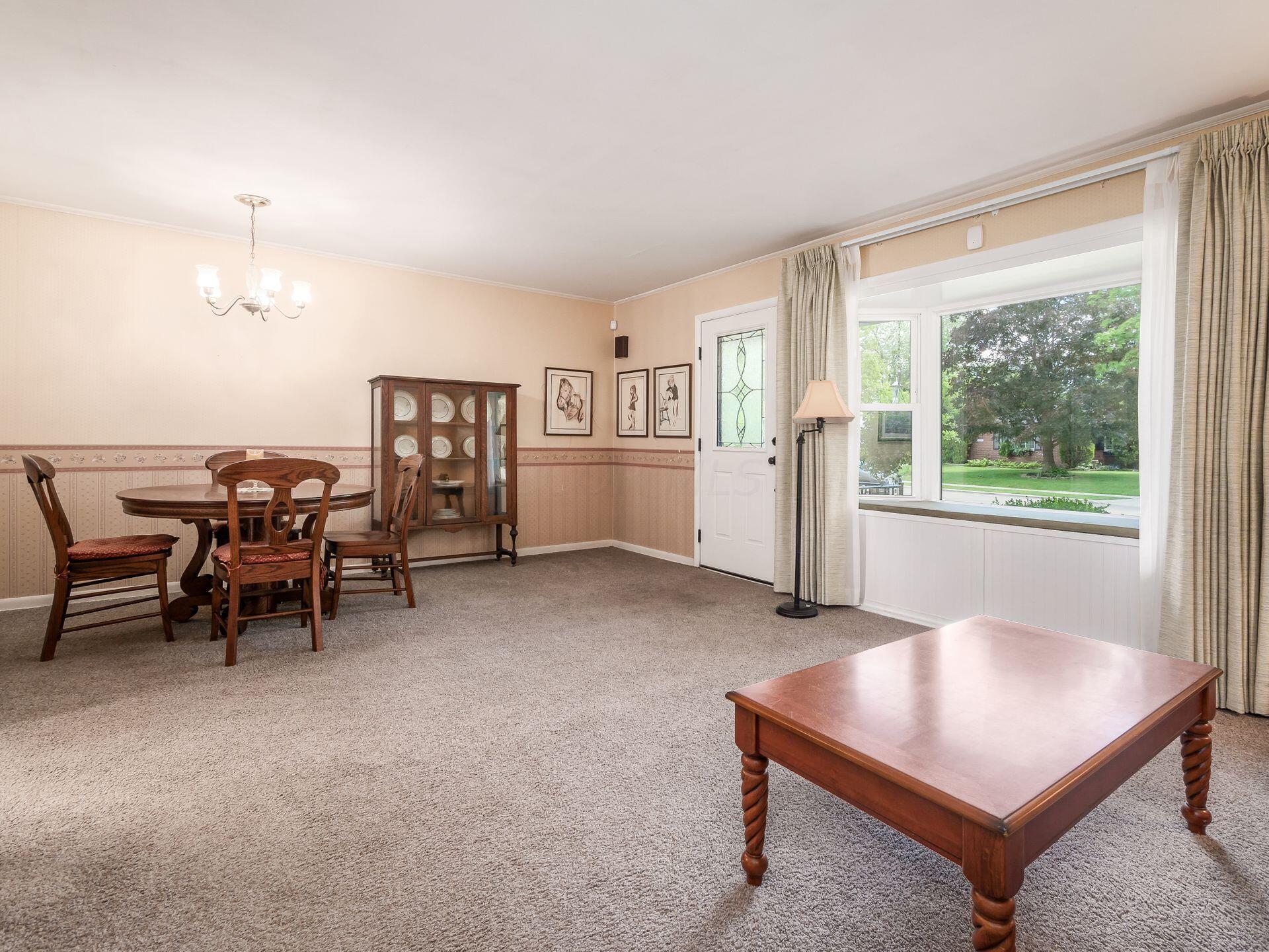 1926 Milden Road Columbus, OH 43221 - Photo 4 of 19 Living room features a bay window and a log burning fireplace with gas starter.