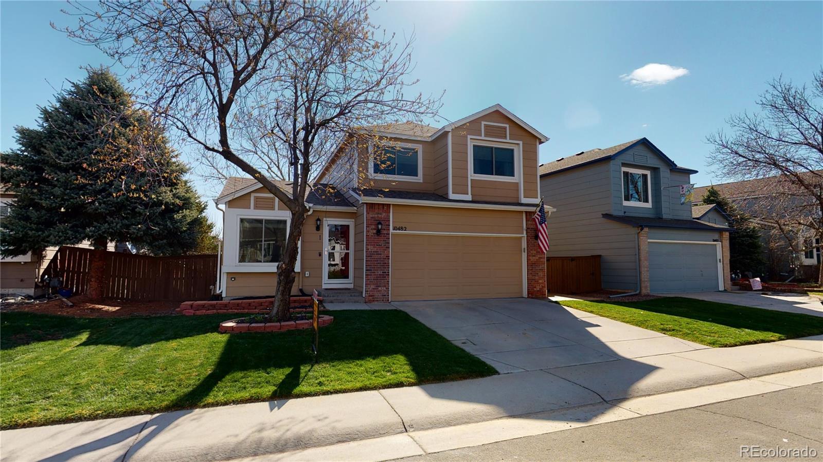 a front view of house with yard and green space