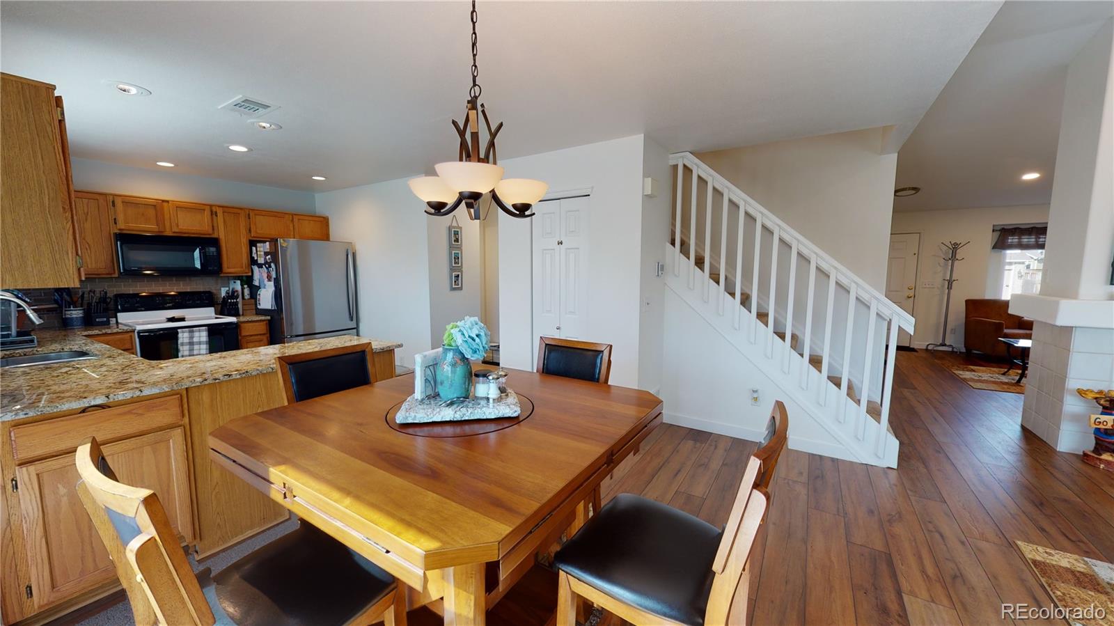 10482 Hyacinth Street Highlands Ranch, CO 80129 - Photo 11 of 40 a view of a dining room and livingroom with furniture wooden floor a chandelier