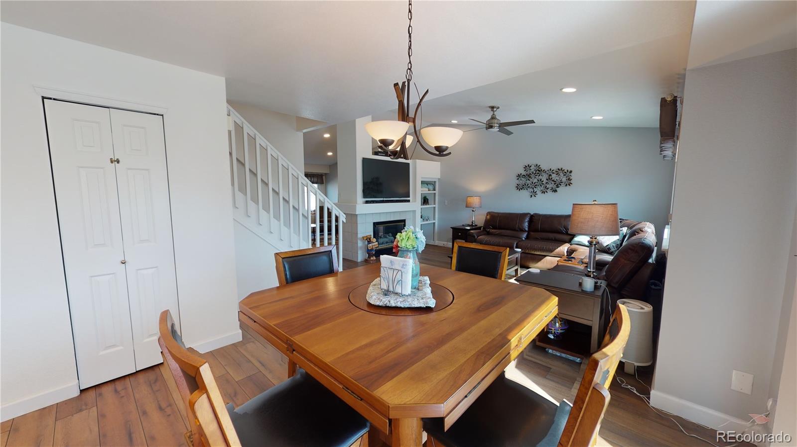 10482 Hyacinth Street Highlands Ranch, CO 80129 - Photo 12 of 40 a view of a dining room with furniture and wooden floor