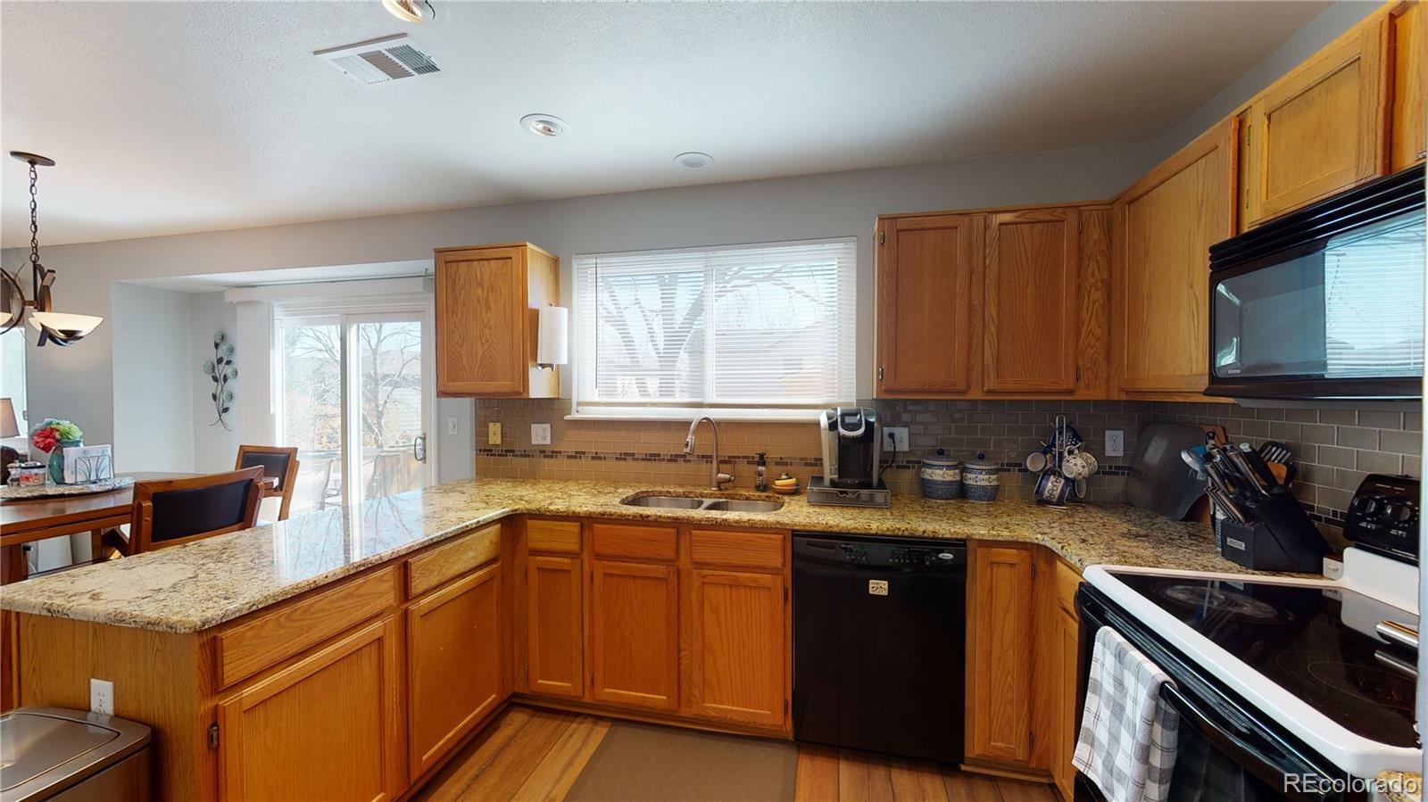 10482 Hyacinth Street Highlands Ranch, CO 80129 - Photo 14 of 40 a kitchen with a sink a stove and cabinets