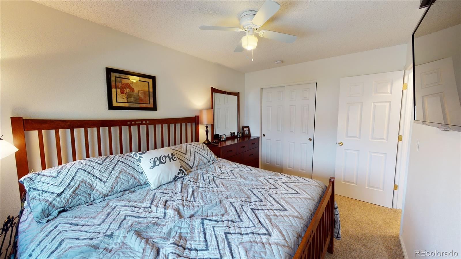 10482 Hyacinth Street Highlands Ranch, CO 80129 - Photo 18 of 40 a bed sitting in a bedroom and a chandelier