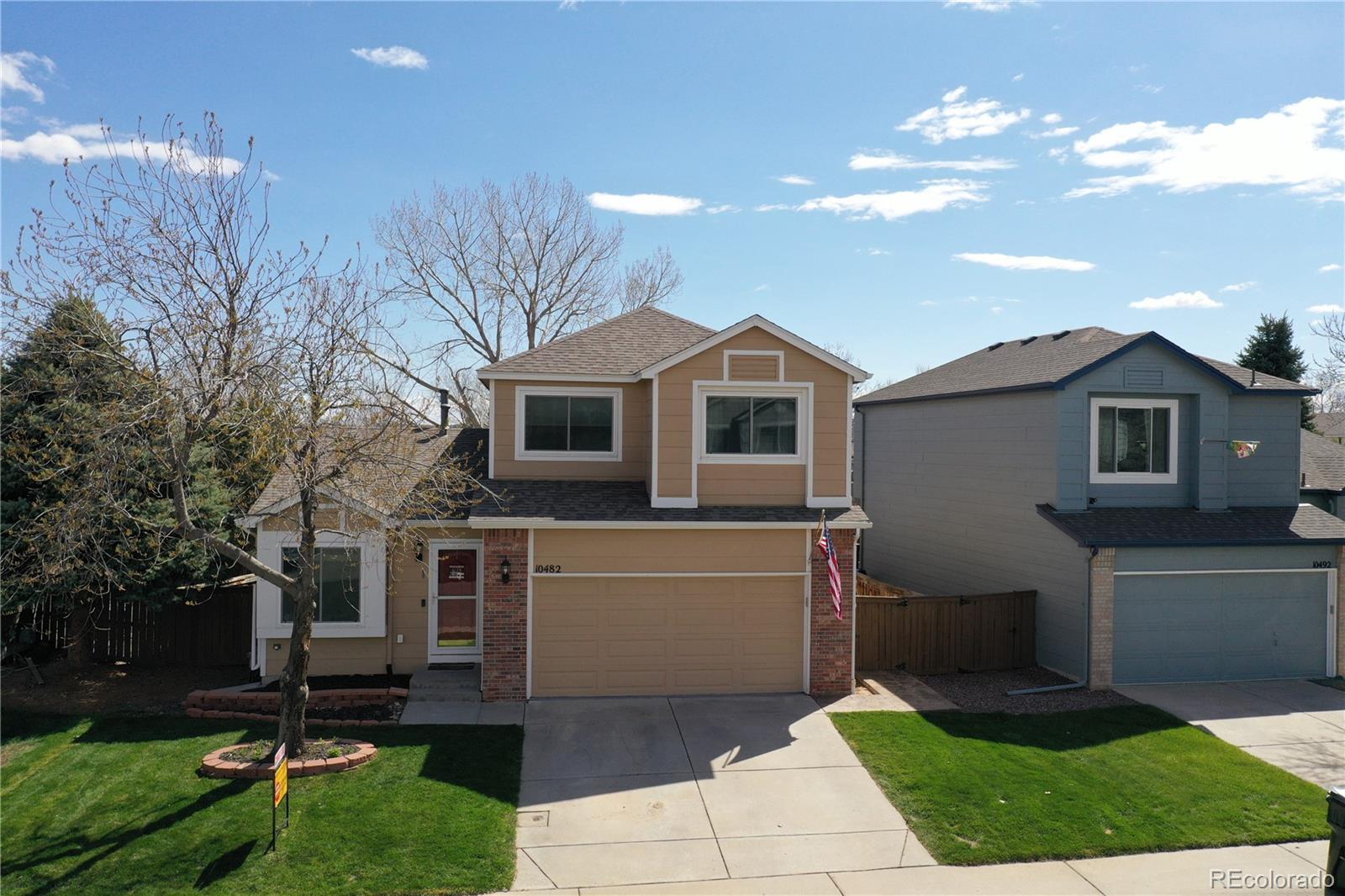 10482 Hyacinth Street Highlands Ranch, CO 80129 - Photo 2 of 40 a front view of a house with a garden