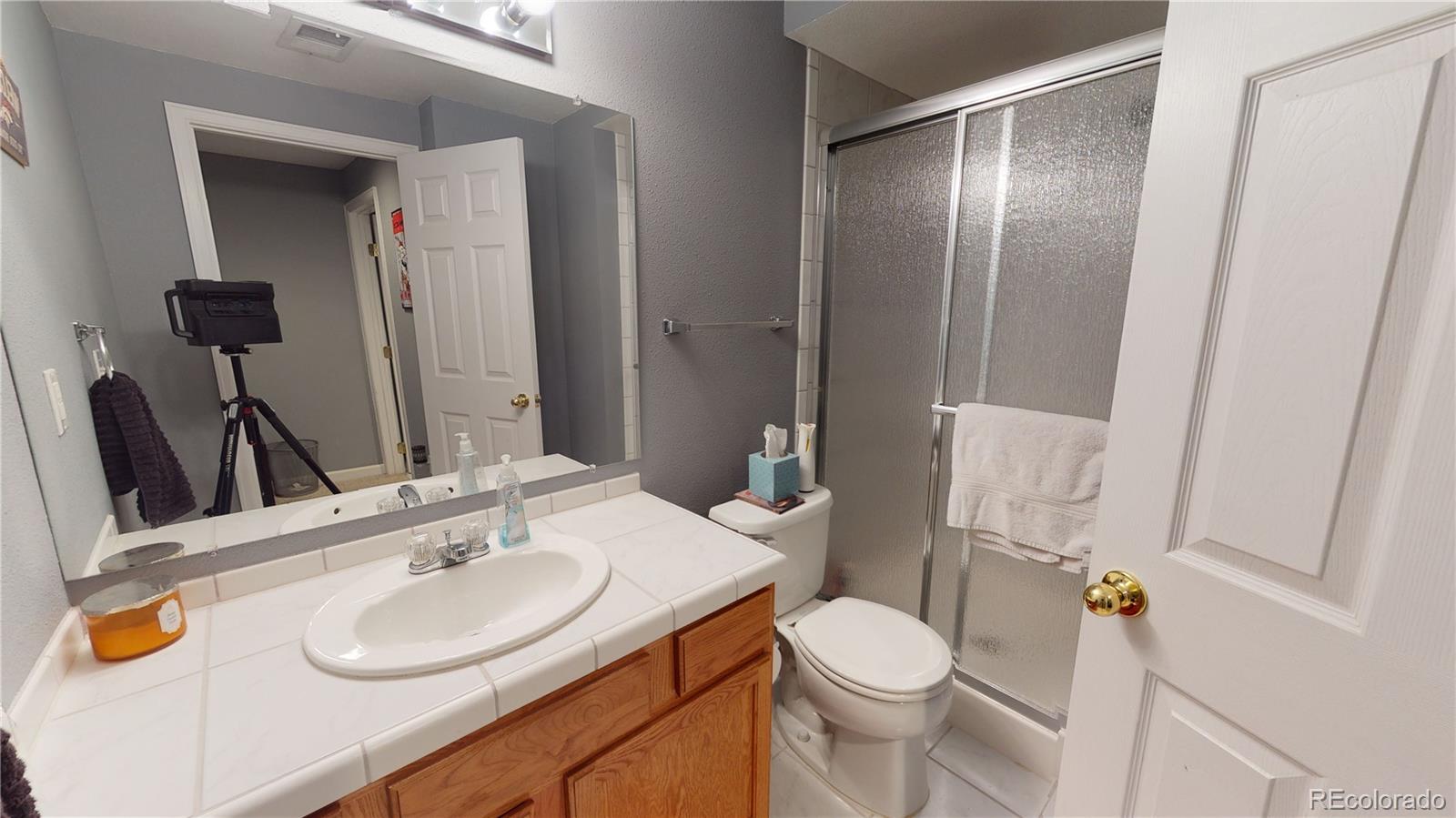 10482 Hyacinth Street Highlands Ranch, CO 80129 - Photo 23 of 40 a bathroom with a sink toilet and shower