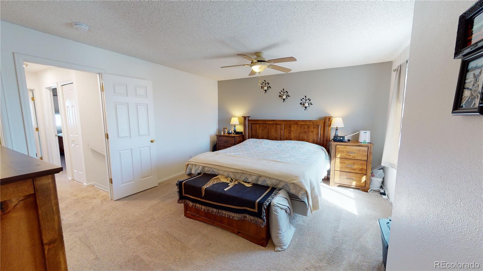 10482 Hyacinth Street Highlands Ranch, CO 80129 - Photo 26 of 40 a bedroom with a bed and a chandelier