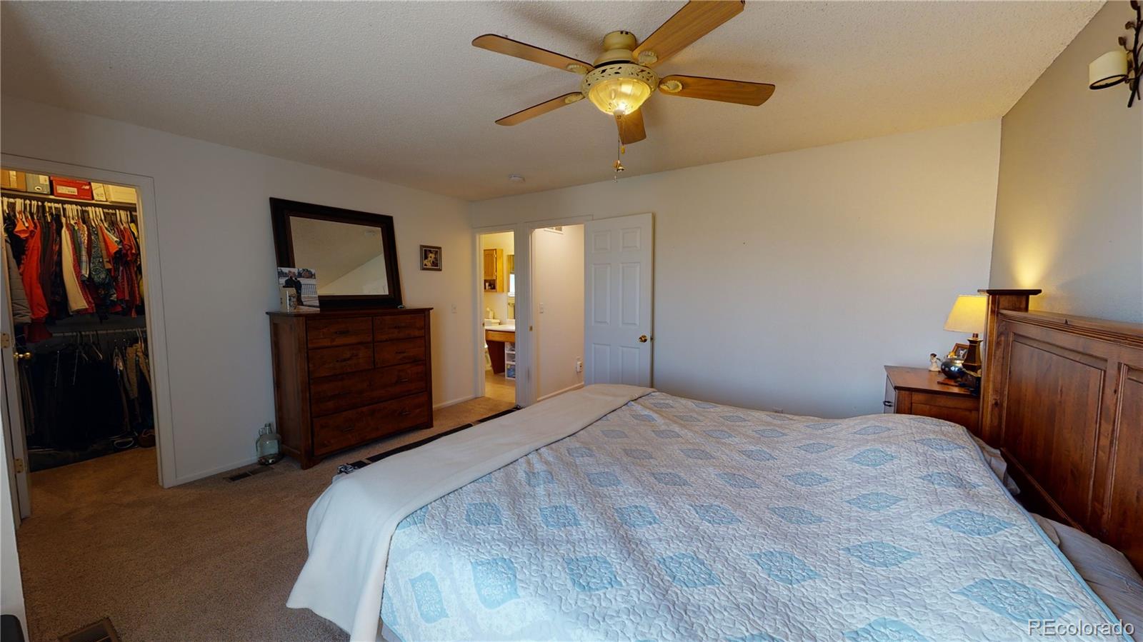 10482 Hyacinth Street Highlands Ranch, CO 80129 - Photo 28 of 40 a bedroom with a bed and a chandelier