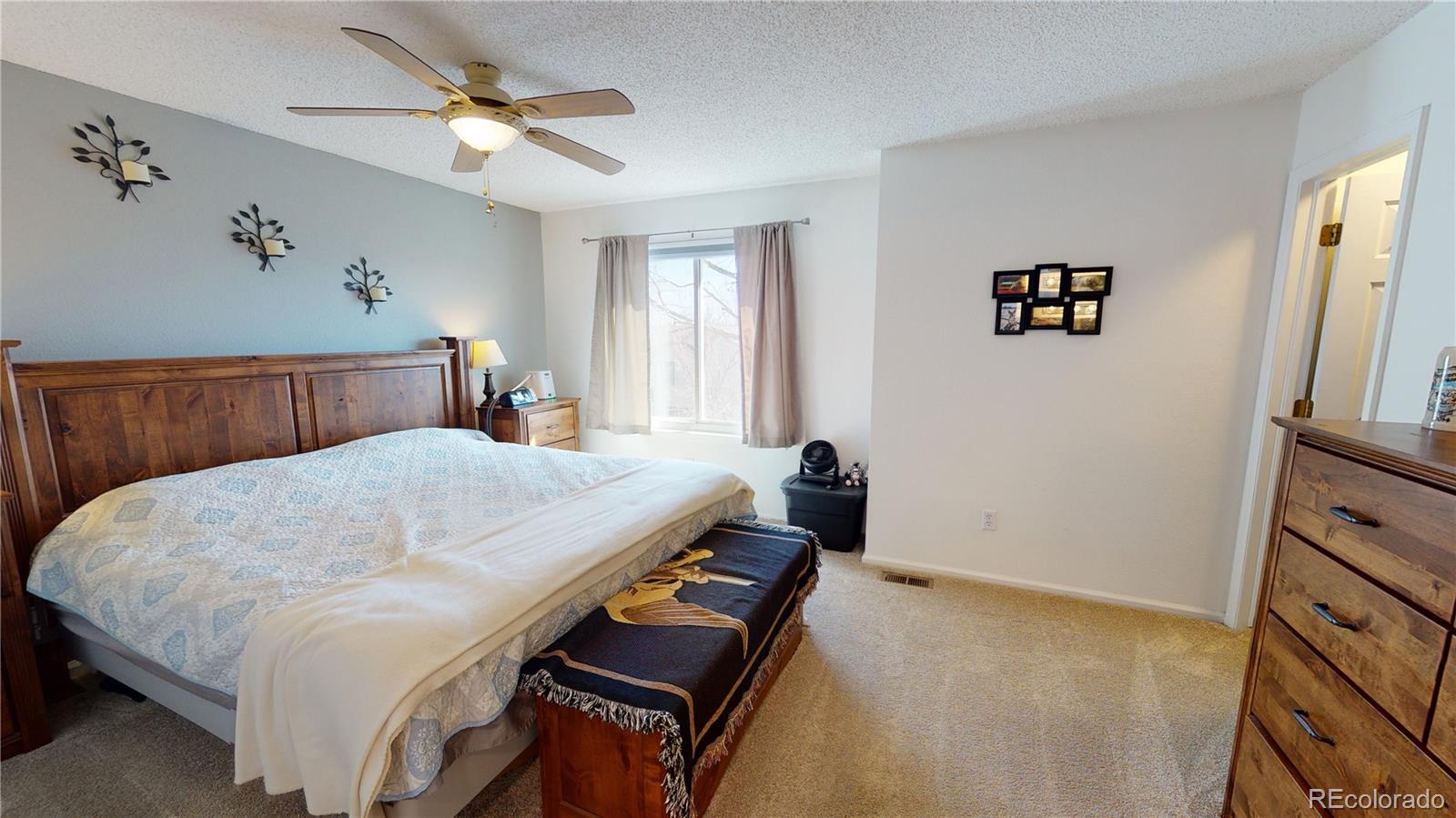10482 Hyacinth Street Highlands Ranch, CO 80129 - Photo 29 of 40 a bedroom with a bed and a dresser