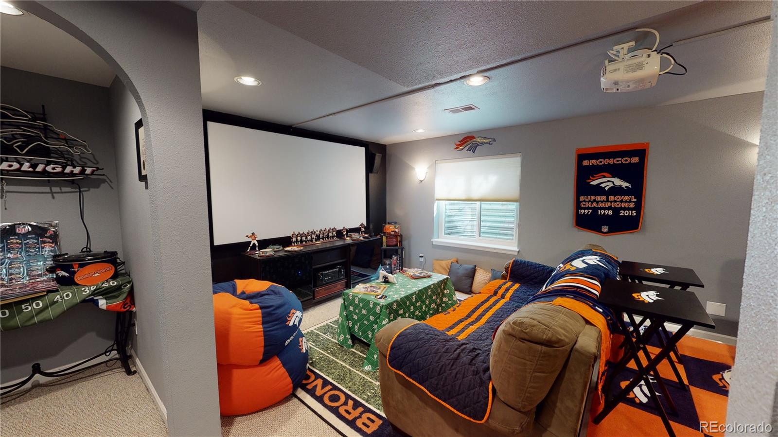 10482 Hyacinth Street Highlands Ranch, CO 80129 - Photo 31 of 40 a living room with furniture a flat screen tv and a large window