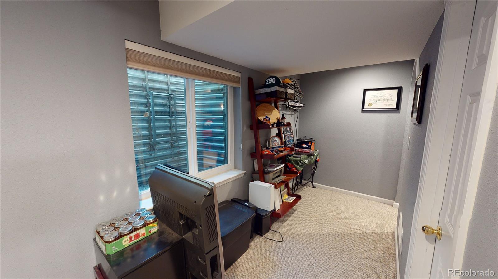 10482 Hyacinth Street Highlands Ranch, CO 80129 - Photo 32 of 40 a view of a livingroom with furniture and a window