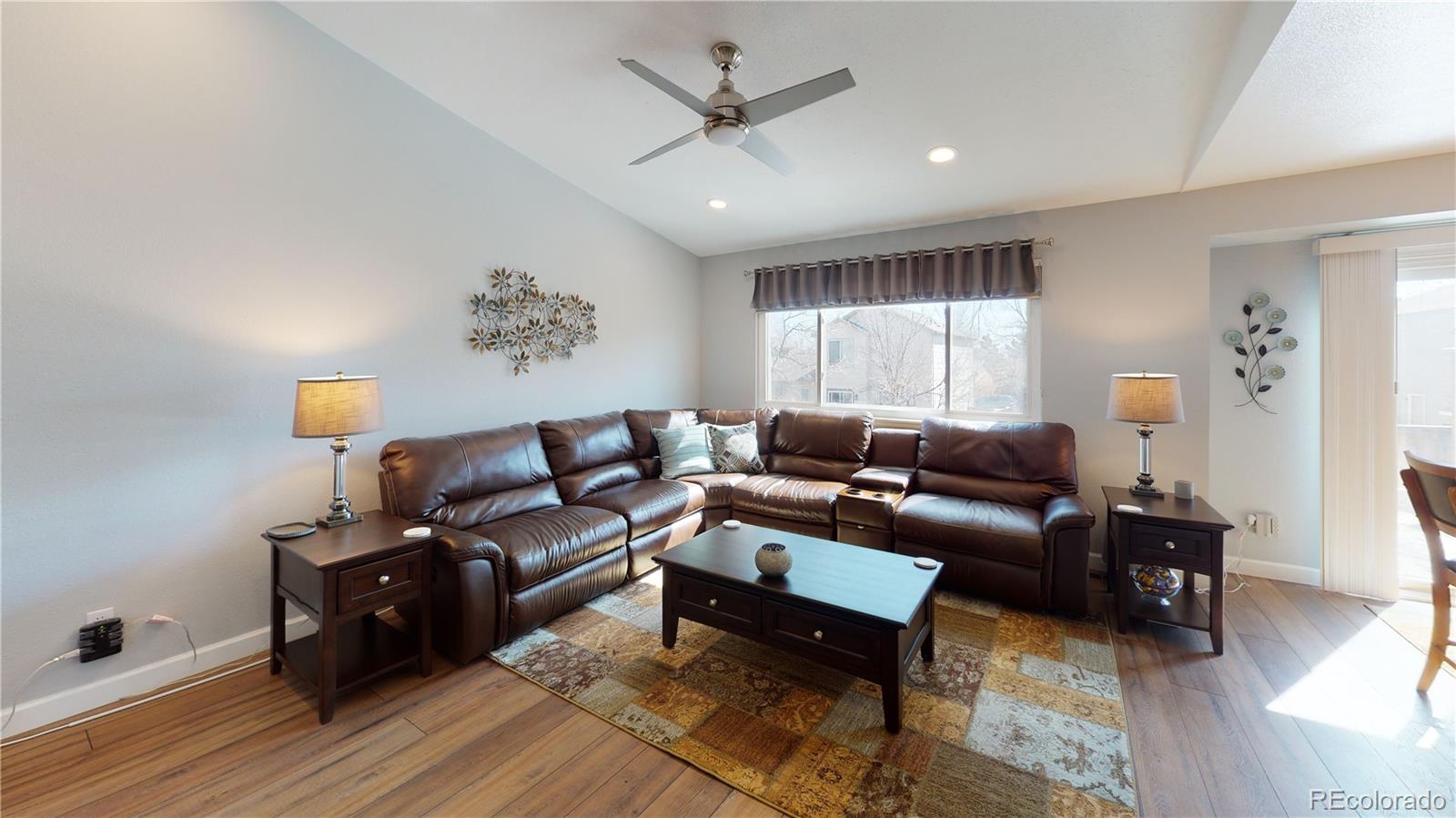 10482 Hyacinth Street Highlands Ranch, CO 80129 - Photo 4 of 40 a living room with furniture and a ceiling fan