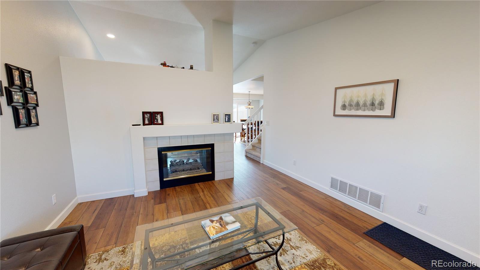 10482 Hyacinth Street Highlands Ranch, CO 80129 - Photo 5 of 40 a living room with furniture and a fireplace