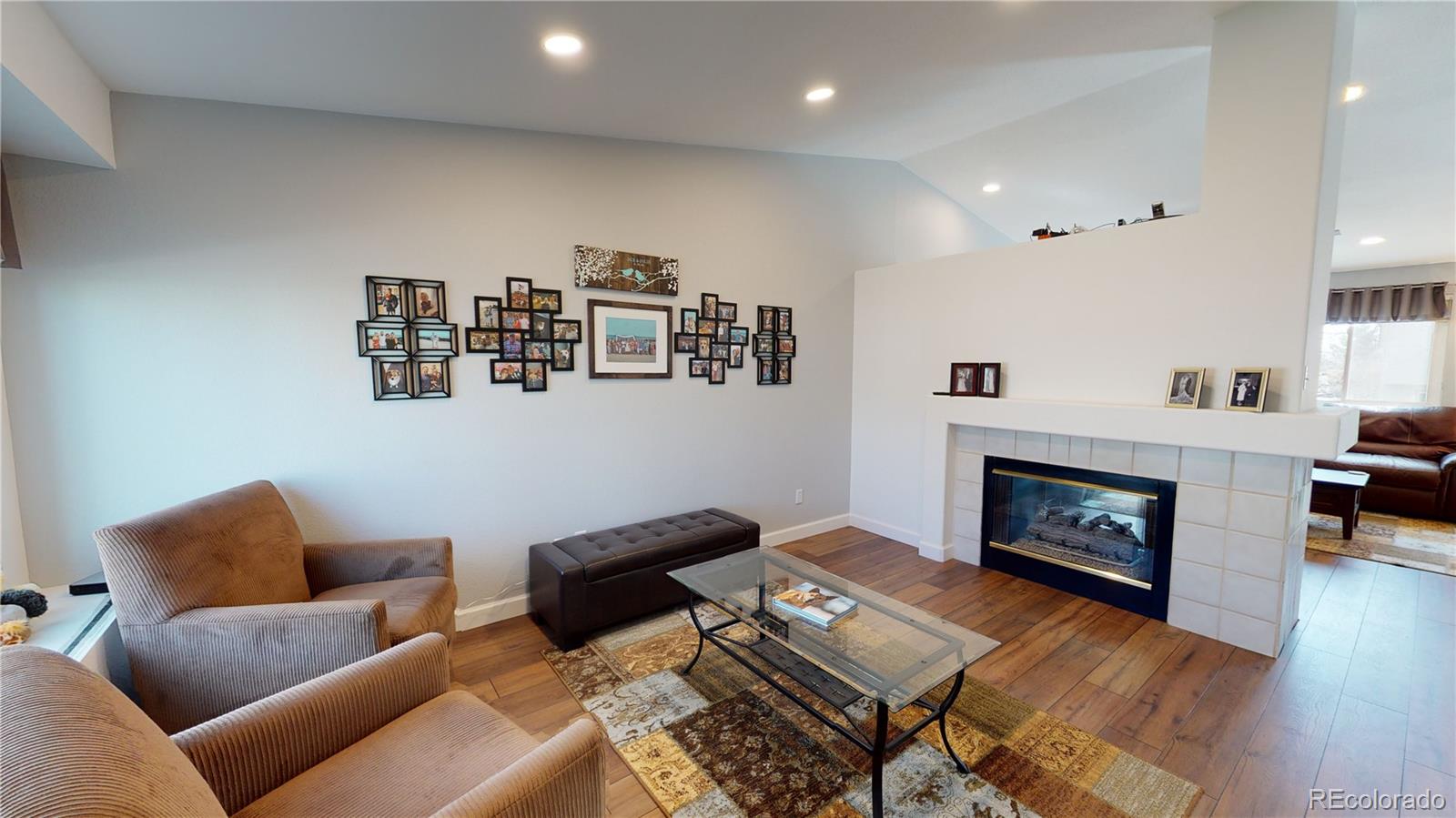 10482 Hyacinth Street Highlands Ranch, CO 80129 - Photo 6 of 40 a living room with furniture and a fireplace