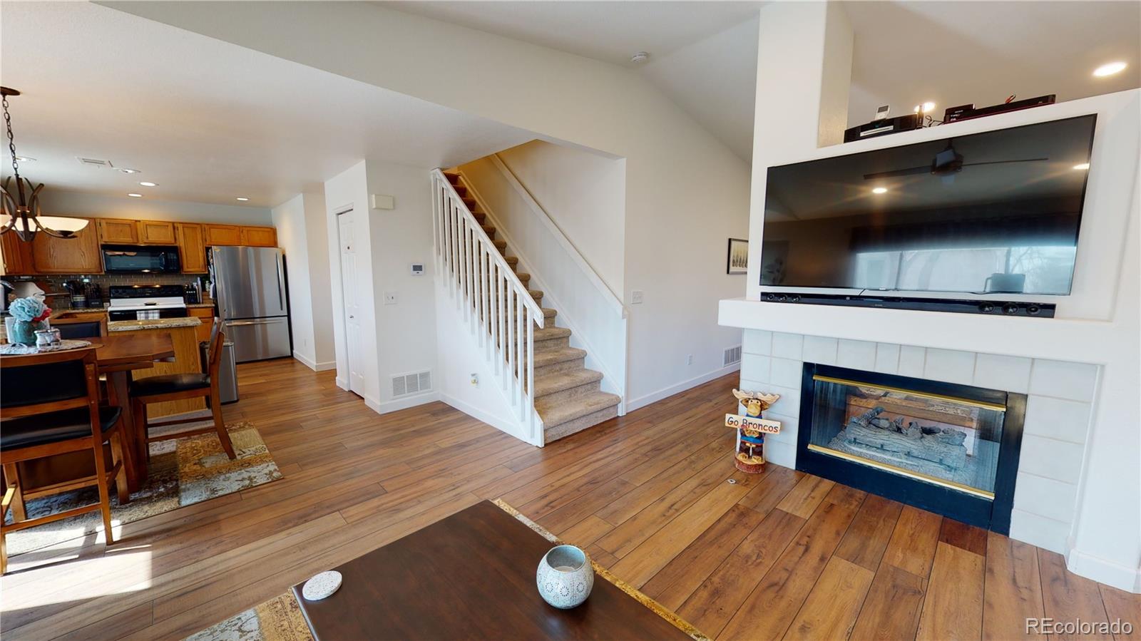 10482 Hyacinth Street Highlands Ranch, CO 80129 - Photo 9 of 40 a living room with furniture and a flat screen tv