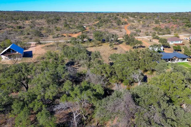 an aerial view of house with yard and ocean view