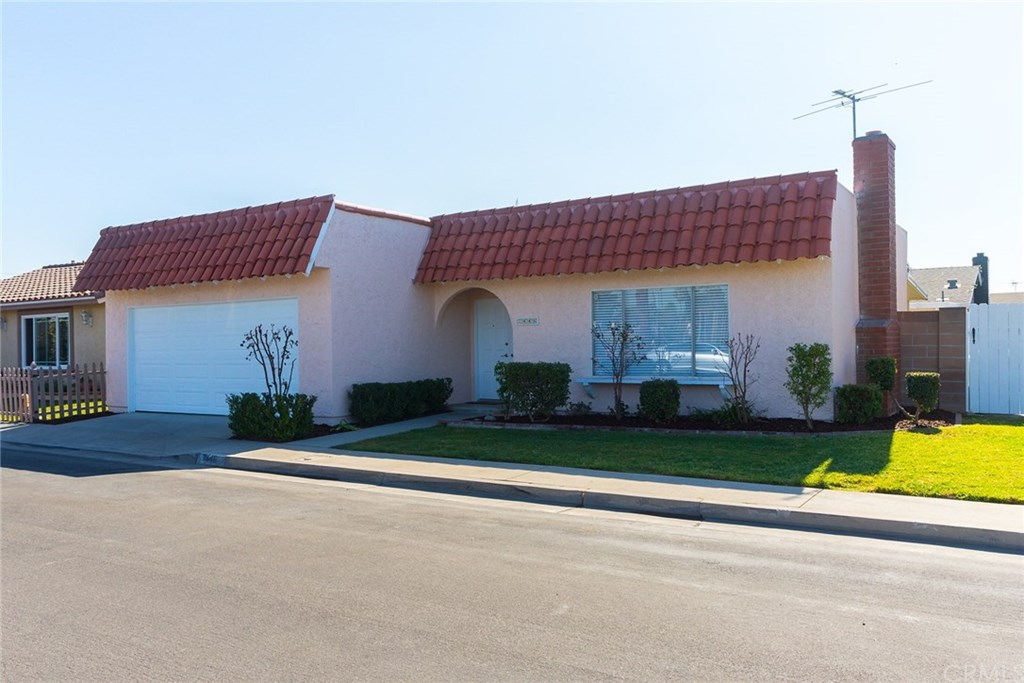 7446 El Morro Way Buena Park, CA 90620 - Photo 2 of 23 a front view of a house with a garden and plants