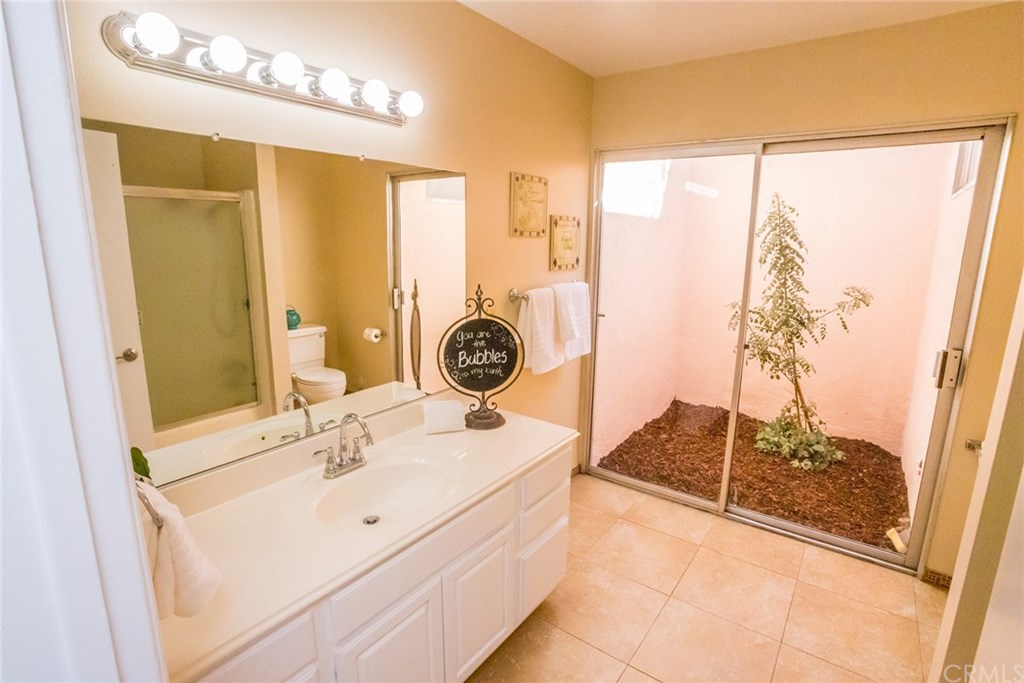 7446 El Morro Way Buena Park, CA 90620 - Photo 13 of 23 a bathroom with a sink and a mirror