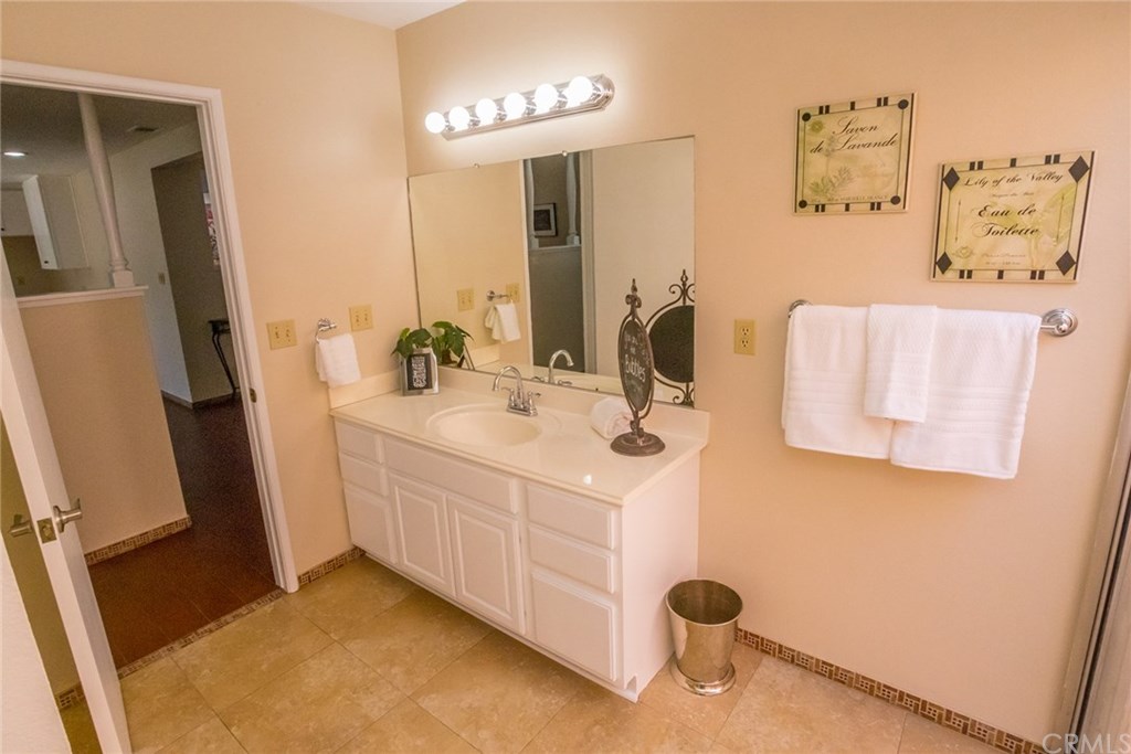 7446 El Morro Way Buena Park, CA 90620 - Photo 15 of 23 a bathroom with a sink and a mirror