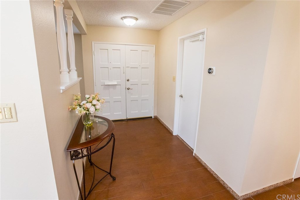 7446 El Morro Way Buena Park, CA 90620 - Photo 3 of 23 a view of a hallway with wooden floor
