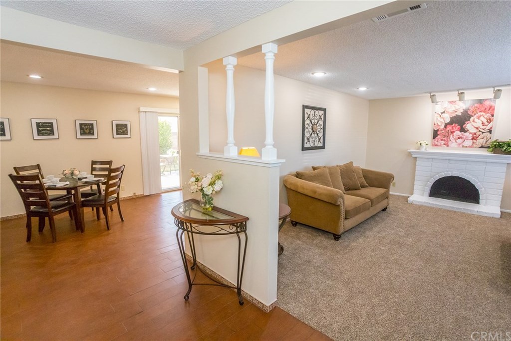 7446 El Morro Way Buena Park, CA 90620 - Photo 5 of 23 a living room with furniture a fireplace and a flat screen tv