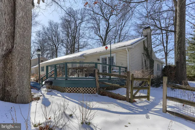 a view of a patio with couches table and chairs and potted plants