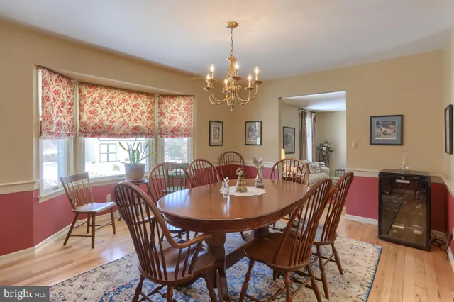 a dining room with furniture a window and wooden floor