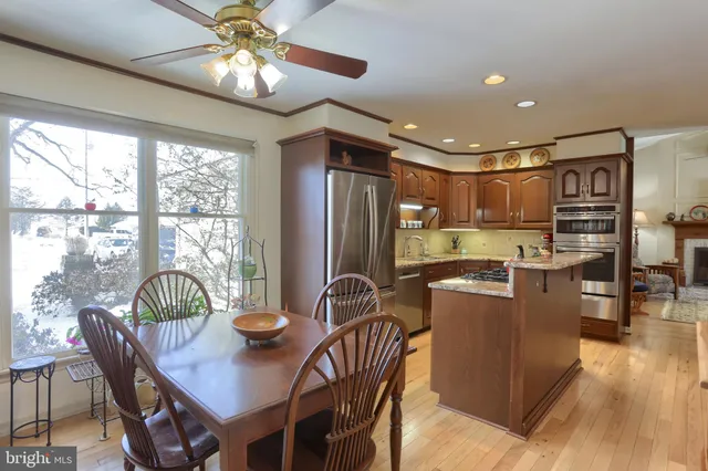 a dining room with furniture window and wooden floor