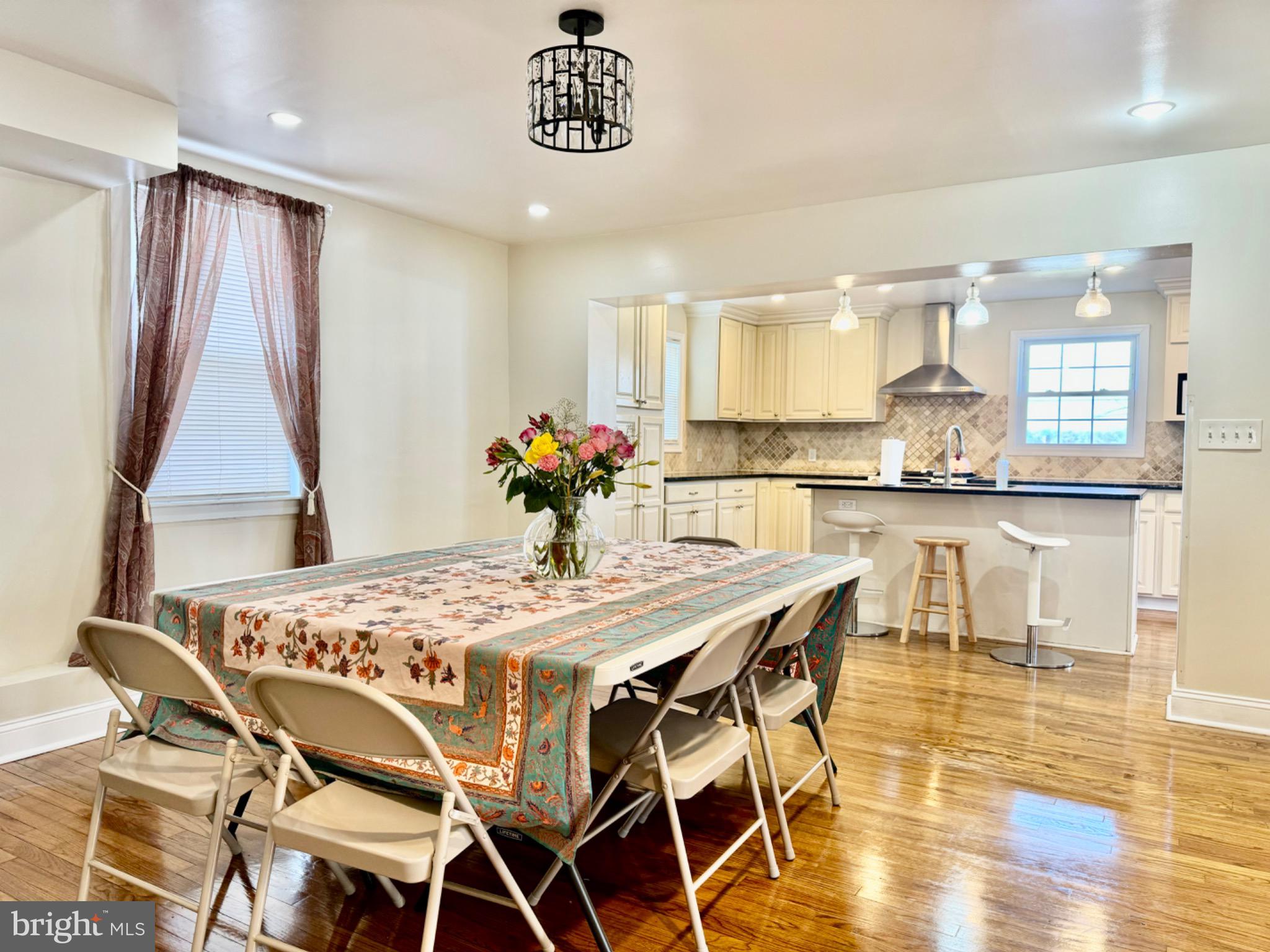 3210 Harford Road Baltimore, MD 21218 - Photo 7 of 33 a dining room with stainless steel appliances kitchen island granite countertop a dining table chairs and granite counter tops
