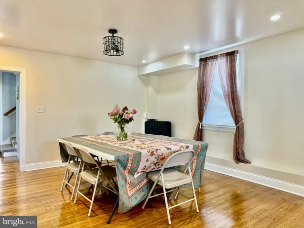 a dining room with furniture and wooden floor