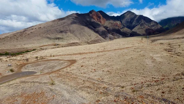 a view of wooden fence in front of a house
