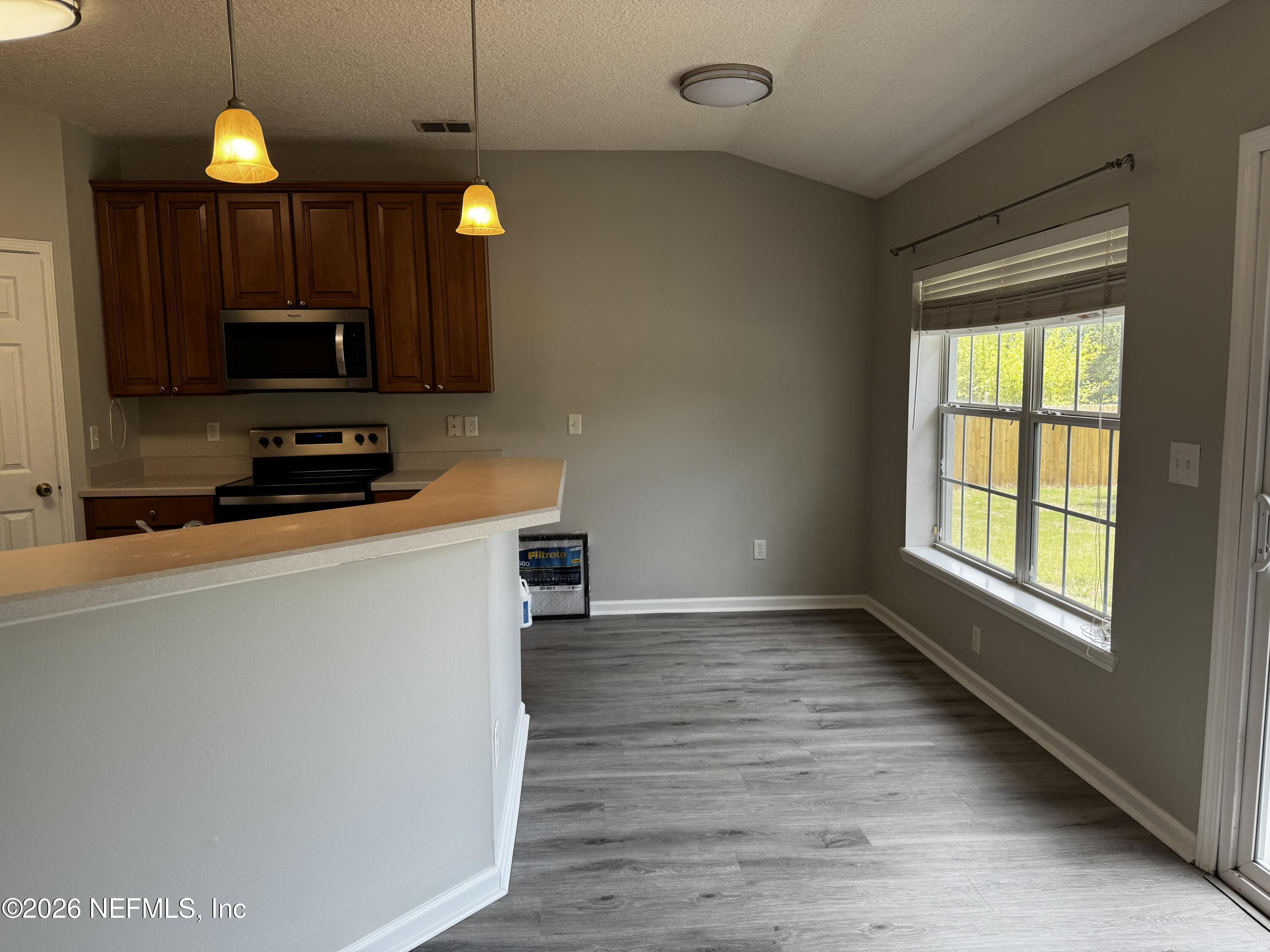 16255 Shellcracker Road Jacksonville, FL 32226 - Photo 19 of 40 a kitchen that has a microwave a sink and a stove top oven