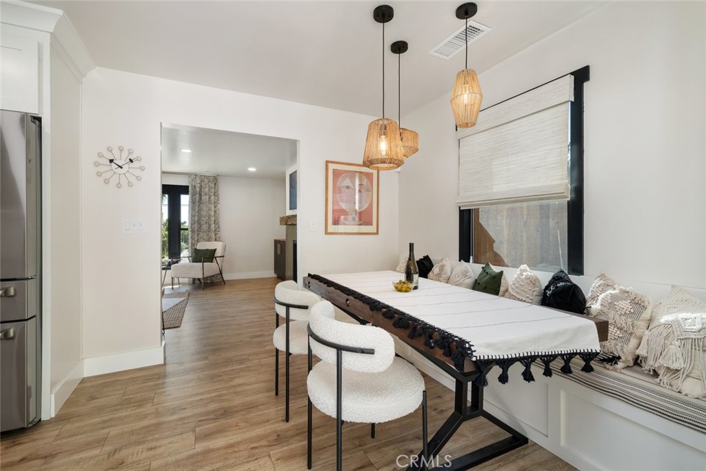 905 Olive Street Paso Robles, CA 93446 - Photo 11 of 61 a view of a dining room and livingroom with furniture wooden floor a chandelier