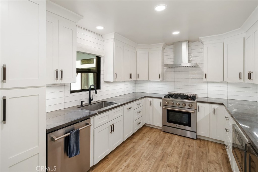 905 Olive Street Paso Robles, CA 93446 - Photo 15 of 61 a kitchen with stainless steel appliances granite countertop a sink stove and cabinets