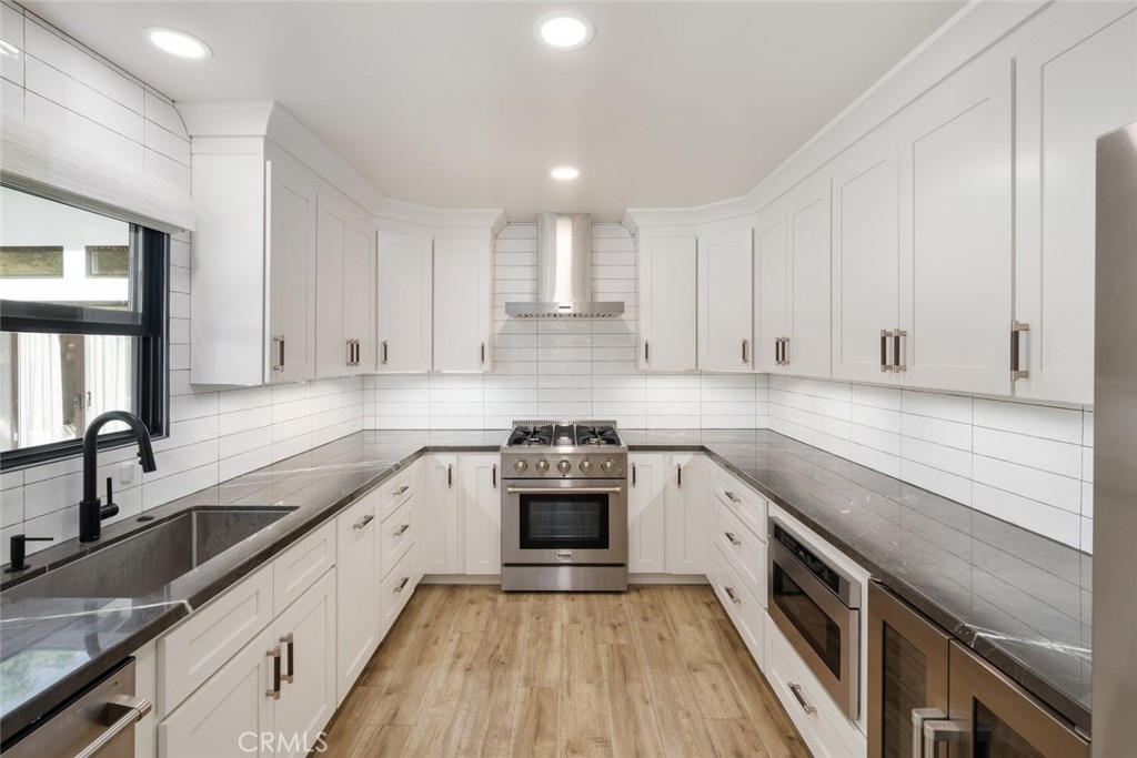 905 Olive Street Paso Robles, CA 93446 - Photo 16 of 61 a kitchen with a sink stove top oven and cabinets