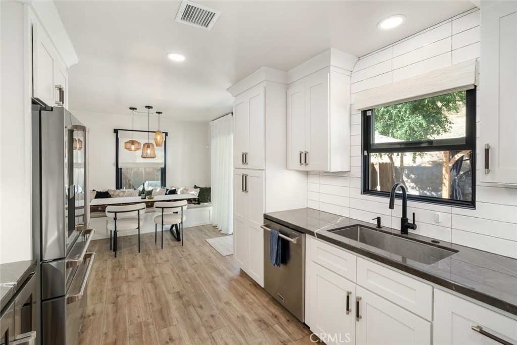 905 Olive Street Paso Robles, CA 93446 - Photo 18 of 61 a kitchen with granite countertop a sink stove and cabinets