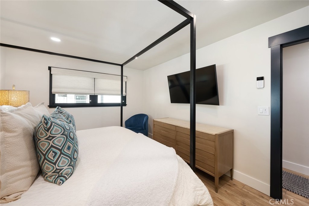 905 Olive Street Paso Robles, CA 93446 - Photo 20 of 61 a bedroom with a large bed and a flat tv screen on the dresser