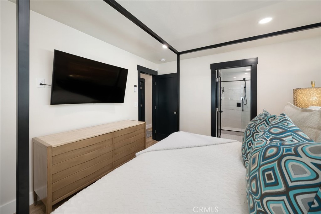 905 Olive Street Paso Robles, CA 93446 - Photo 21 of 61 a bedroom with a bed and a flat screen tv