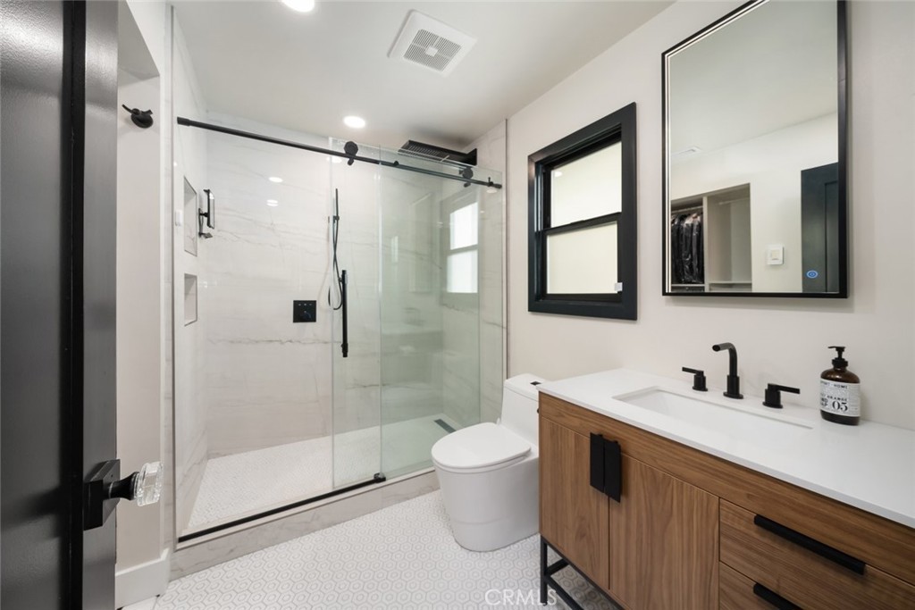905 Olive Street Paso Robles, CA 93446 - Photo 22 of 61 a bathroom with a double vanity sink mirror and toilet