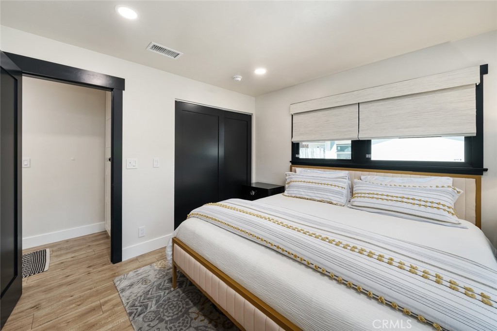 905 Olive Street Paso Robles, CA 93446 - Photo 27 of 61 a spacious bedroom with a bed and a large mirror