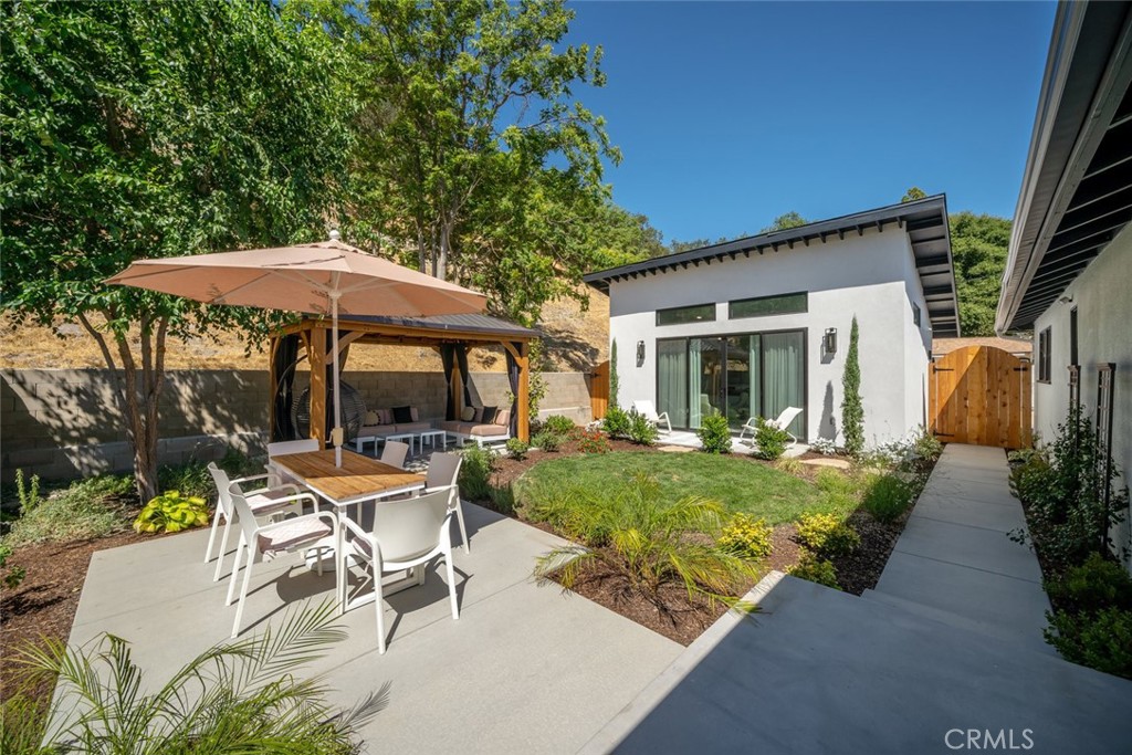 905 Olive Street Paso Robles, CA 93446 - Photo 32 of 61 a view of a house with backyard sitting area and garden