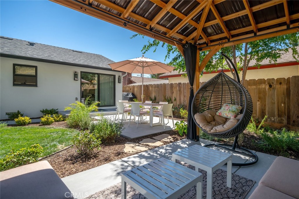 905 Olive Street Paso Robles, CA 93446 - Photo 37 of 61 a view of a backyard with table and chairs potted plants