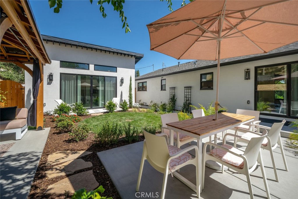 905 Olive Street Paso Robles, CA 93446 - Photo 39 of 61 a view of a patio with table and chairs under an umbrella