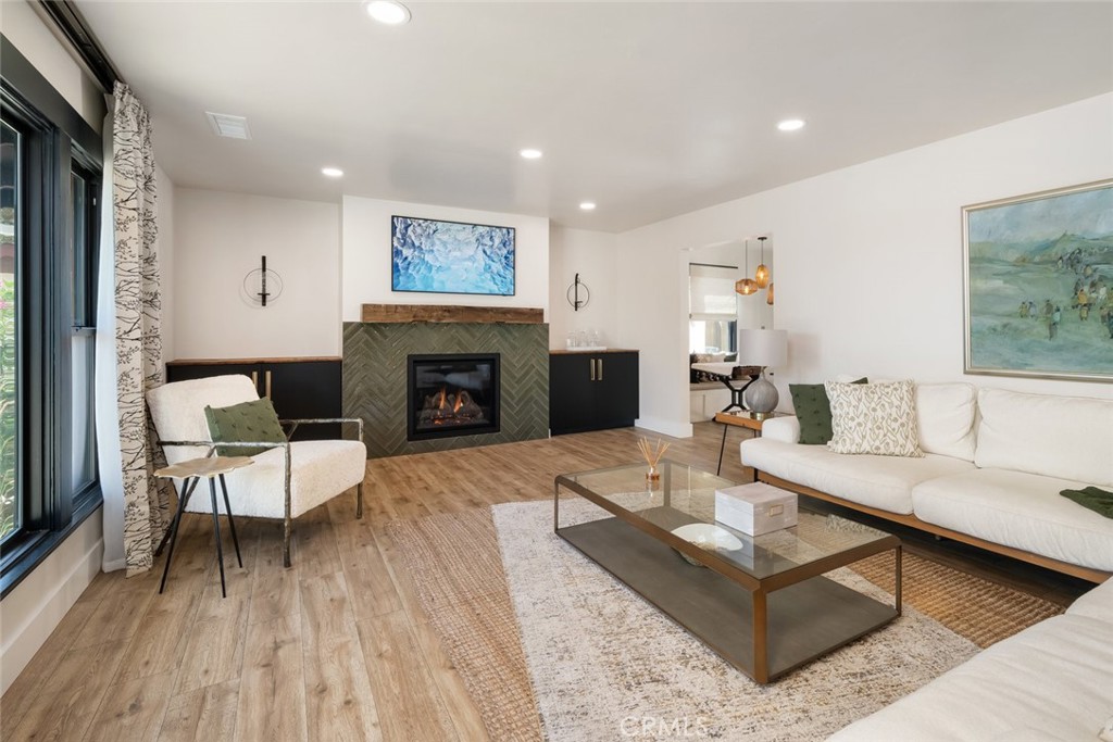 905 Olive Street Paso Robles, CA 93446 - Photo 4 of 61 a living room with fireplace furniture and a wooden floor