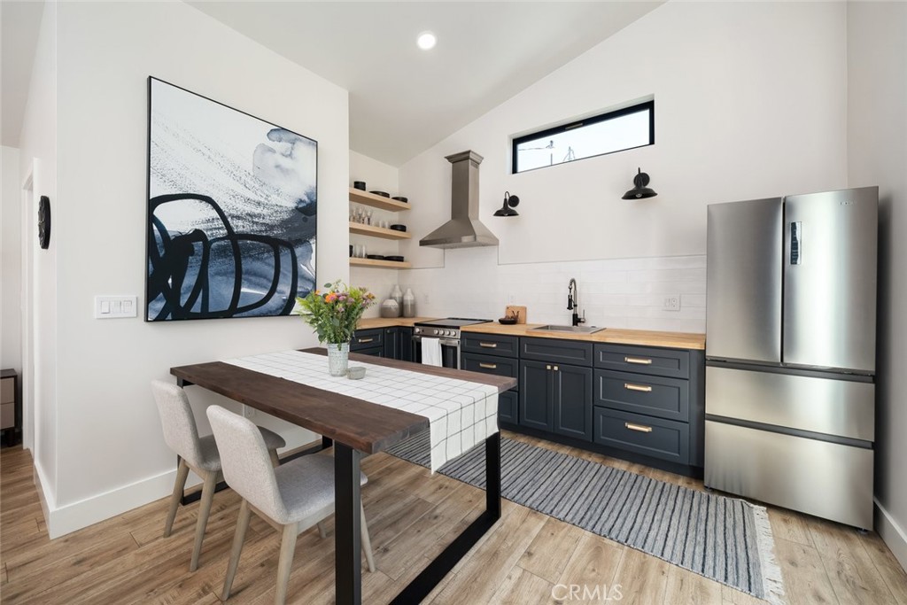 905 Olive Street Paso Robles, CA 93446 - Photo 45 of 61 a kitchen with a refrigerator and wooden cabinets