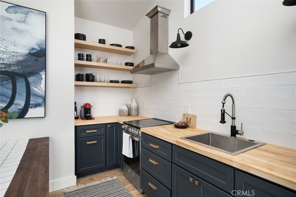 905 Olive Street Paso Robles, CA 93446 - Photo 46 of 61 a kitchen with stainless steel appliances granite countertop a sink and cabinets