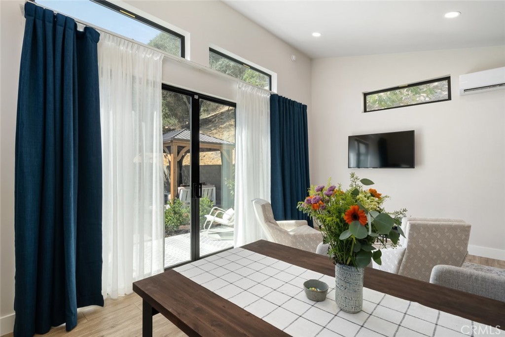 905 Olive Street Paso Robles, CA 93446 - Photo 47 of 61 a living room with furniture potted plant and a flat screen tv