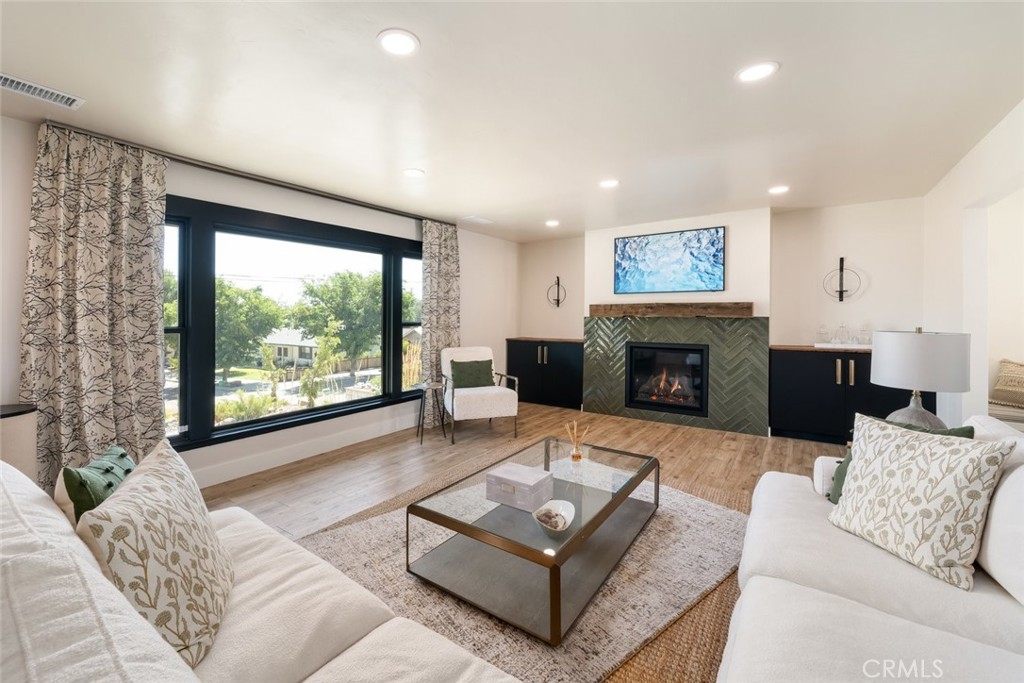 905 Olive Street Paso Robles, CA 93446 - Photo 7 of 61 a living room with furniture large window and a fireplace