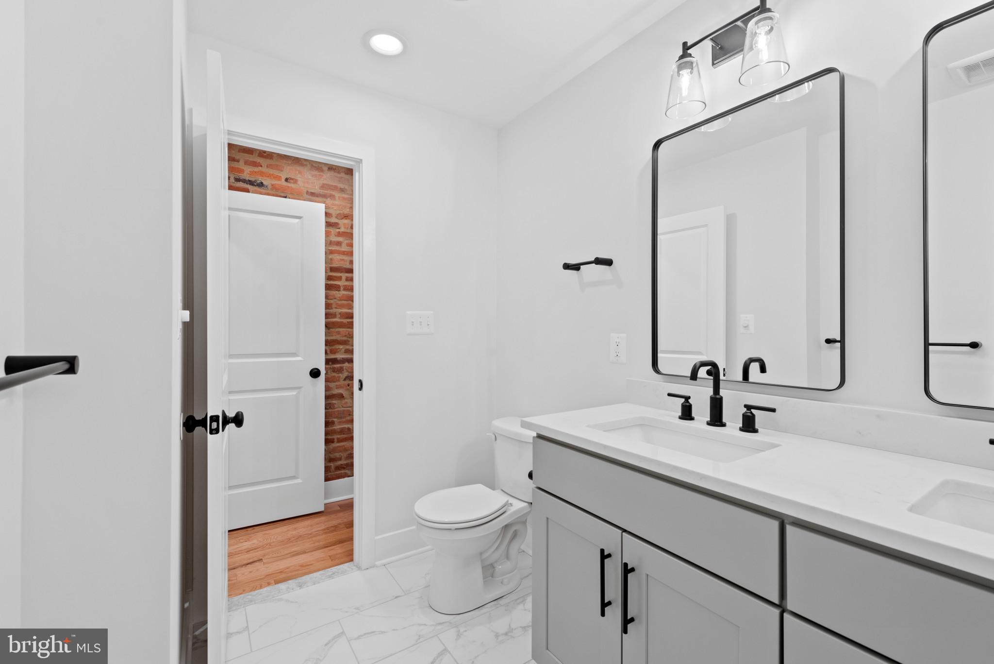 1434 Marshall Street Baltimore, MD 21230 - Photo 30 of 40 a bathroom with a sink a toilet and shower