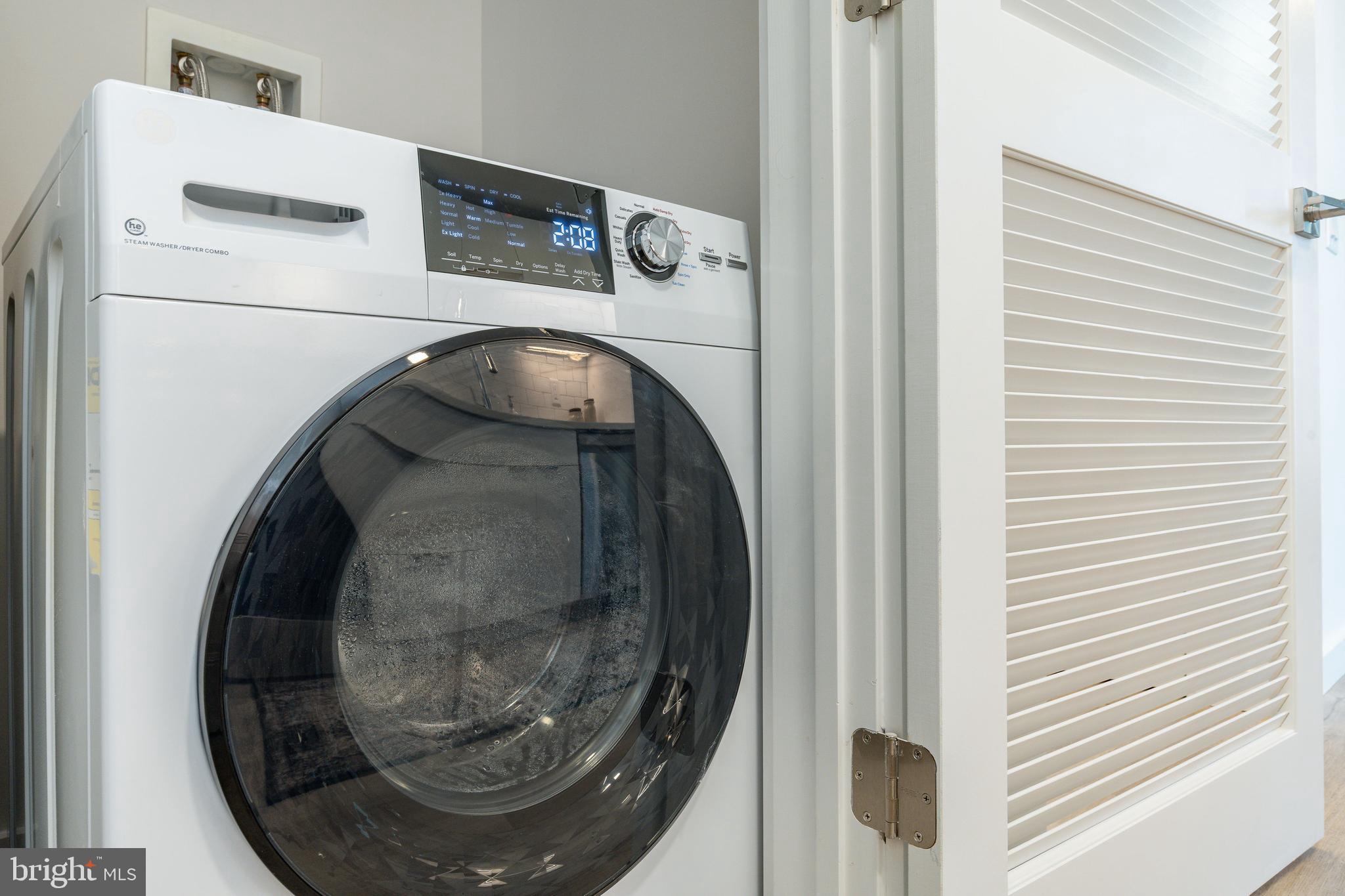 1130 North Delaware Avenue, Unit 307 Philadelphia, PA 19125 - Photo 11 of 30 a close view of utility room with washer and dryer